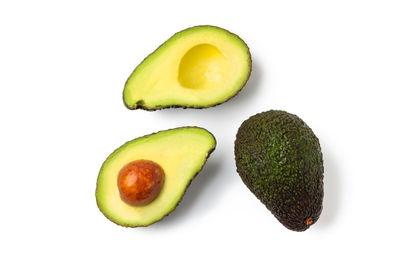 Close-up of green fruits against white background