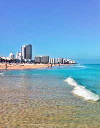 View of beach with city in background