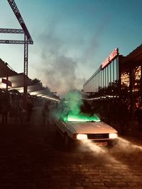 Illuminated city against sky at night