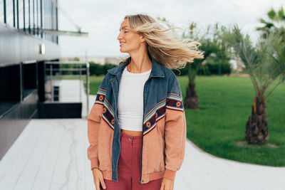 Portrait of woman with blowing blond hair.