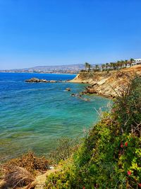 Scenic view of sea against clear blue sky