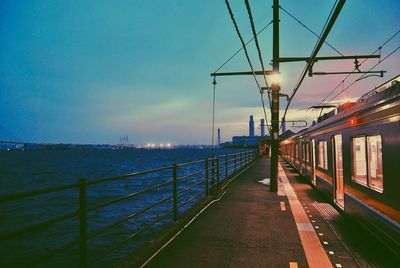 Railway bridge over sea against sky