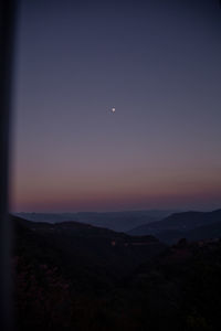 Scenic view of silhouette landscape against sky at night