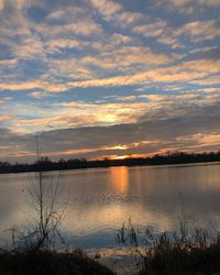 Scenic view of lake against orange sky