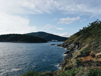 Scenic view of sea and mountains against sky