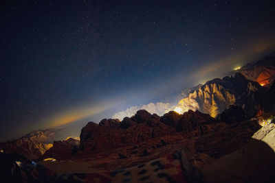 Scenic view of mountains against sky at night