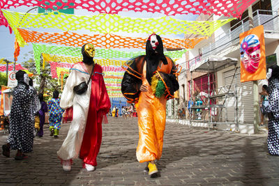 Group of people wearing carnival mask