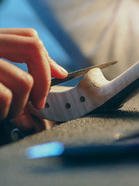 Cropped hand of woman using mobile phone