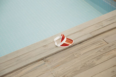 High angle view of sunglasses on table by swimming pool