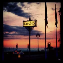 Information sign on road at sunset