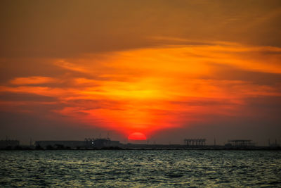 Scenic view of sea against orange sky