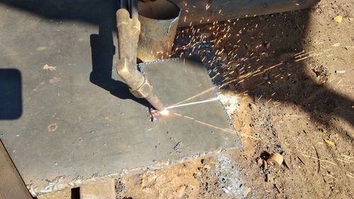 High angle view of man working on metal