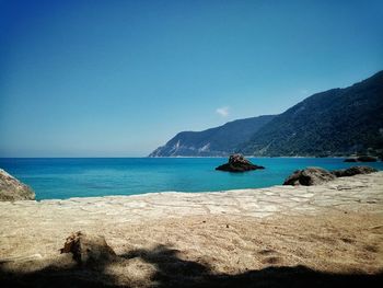 Scenic view of sea against clear blue sky