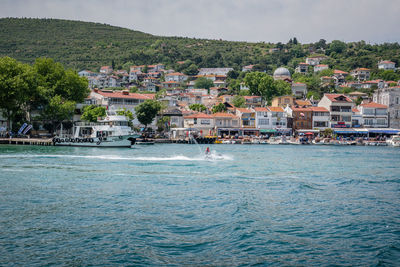 Scenic view of sea by buildings against sky