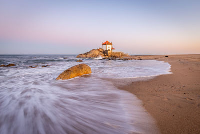 Scenic view of sea against clear sky during sunset