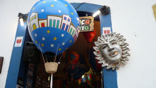 Low angle view of colorful balloon decoration at store entrance