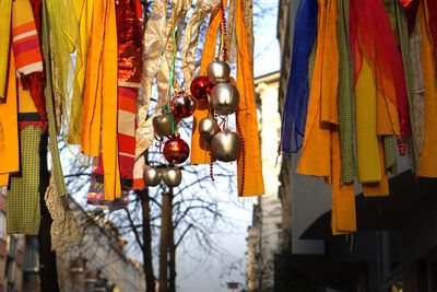 Low angle view of lanterns hanging on tree against sky