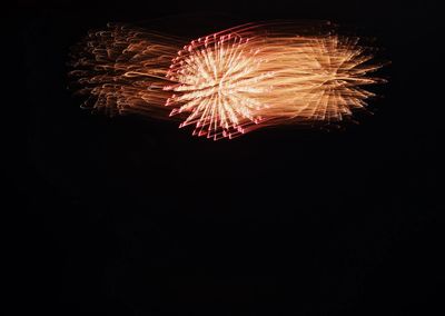 Low angle view of firework display at night