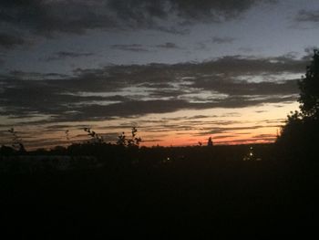 Scenic view of silhouette trees against sky at sunset