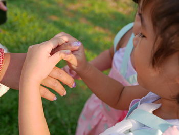 Midsection of couple holding hands
