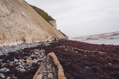 Rock formations by sea against sky