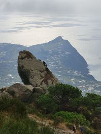 Scenic view of sea and mountains against sky