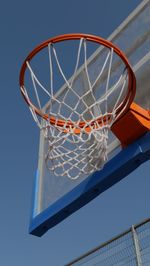 Low angle view of basketball hoop against blue sky