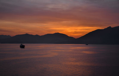 Scenic view of sea against orange sky