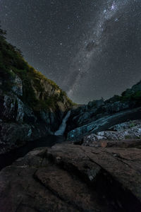 Scenic view of rocks at night against sky