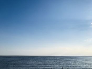 Scenic view of sea against blue sky