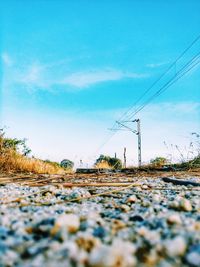 Surface level of electricity pylon against blue sky