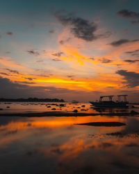 Scenic view of sea against orange sky