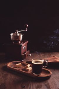 Close-up of coffee cup on table against black background