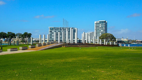 Buildings in park against blue sky