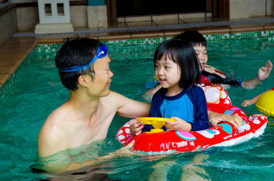 Happy family in swimming pool