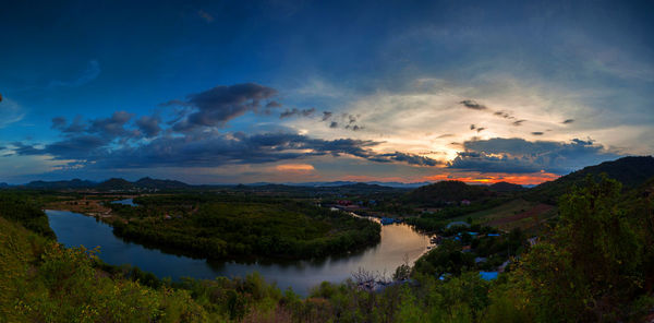 Scenic view of river against sky at sunset