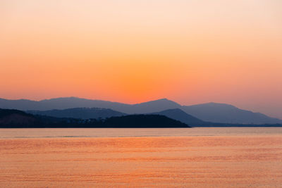 Scenic view of sea against romantic sky at sunset