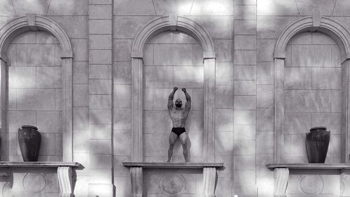 Digital composite image of woman standing against building