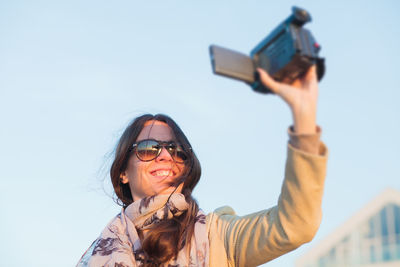 Portrait of woman photographing