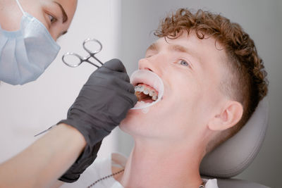 Close-up of woman holding dentures