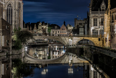 Scenic view of bridge reflected in canal at night