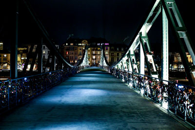 Footbridge in city at night