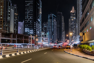 Illuminated city street at night