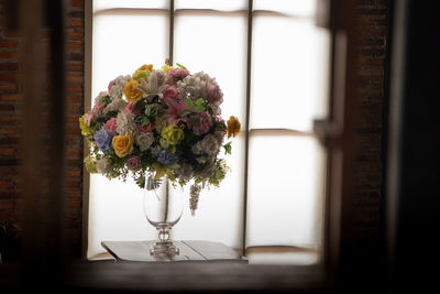 Close-up of vase on table against window