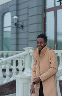 Man looking away while standing outdoors