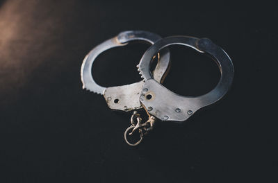 Close-up of metal chain against black background