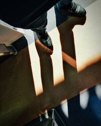 Low section of woman standing on tiled floor