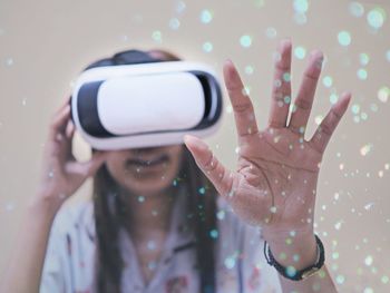 Woman gesturing while using virtual reality simulator