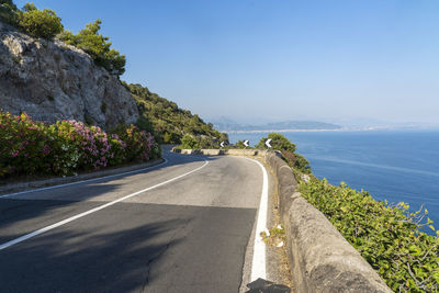 Road by sea against sky