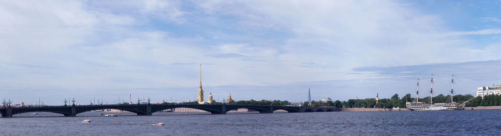 View of bridge over sea against cloudy sky